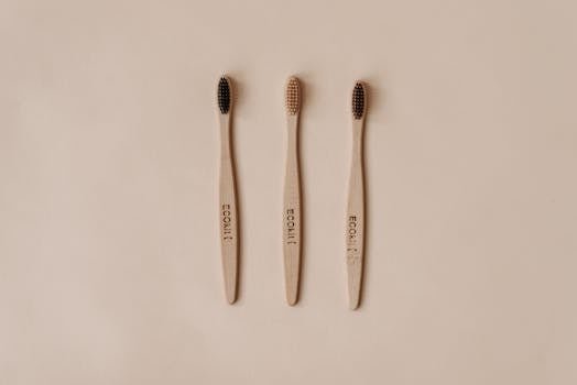 Minimalist flat lay of sustainable wooden toothbrushes promoting eco-friendly dental care.